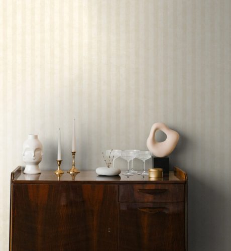 Classic wooden chest of drawers in a minimalist style with a decor of candles, vases in the living room